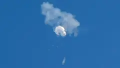 The suspected Chinese spy balloon (surveillance balloon) drifts to the ocean after being shot down off the coast in Surfside Beach, South Carolina, U.S. February 4, 2023.