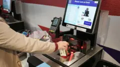 Una mujer utiliza las cajas automáticas para pagar. 