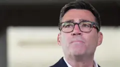 Close-up image of newly confirmed Labour Party leader Andy Burnham, wearing dark glasses