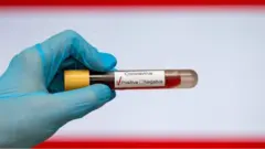 Hand hold coronavirus positive blood sample
