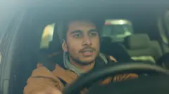Guy driving a car