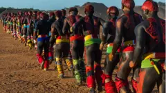 Young men participate in the martial art called Huka-huka