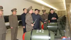 Kim Jong Un with what North Korean state media says are tactical nuclear weapons