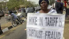 Woman cari placard dey protest