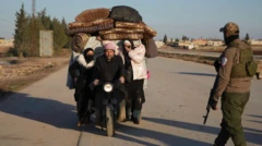 Kaçan insanları taşıyan motorlu bir üç tekerlekli araç yolda ilerlerken, bir Suriye askeri tarafından durdurulmuş. Motora ev eşyaları yüklenmiş ve iki kadın daha taşıyor.