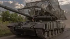 Ukrainian servicemen drive a Soviet-made T-64 tank in the Sumy region, near the border with Russia, on August 11, 2024, 