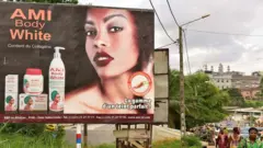 Billboard advertising AMI Body White products next to a road in the Ivory Coast