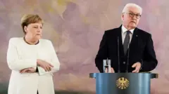 German Chancellor Angela Merkel (L) grips her arms next to German President Frank-Walter Steinmeier while attending the handing over of the certificates of appointment and discharge for the Ministers of Justice at Bellevue Palace in Berlin, Germany, 27 June 2019