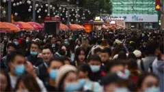 Pedestrians walk in Chengdu, China