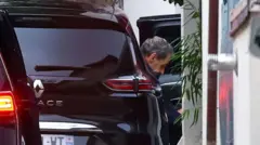 Former French President Nicolas Sarkozy seen climbing out of his car