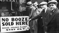 A sign reading n booze sold here in New York, 1929