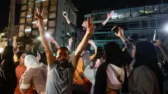 Crowd dey celebrate as displaced pipo return to dia homes for Sidon, in Lebanon
