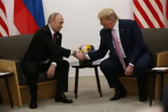 Vladimir Putin and Donald Trump shaking hands