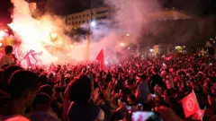 Supporters of Tunisian presidential candidate Kais Saied celebrate unofficial results of the presidential election in the capital Tunis, 13 October 2019