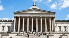 Student sit beneath a dome above columns 