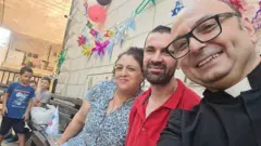 Father Gabriel with a family