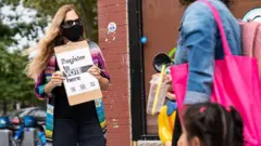 women holding sign about Presidential election in usa