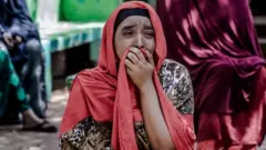 A relative of Yassin Hussein Moyo cries prior to Yassins burial at Kariokor Muslim Cemetery in Nairobi, Kenya on March 31, 2020.
