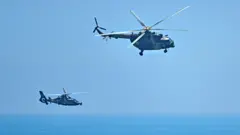 Chinese military helicopters fly past Pingtan island, one of mainland China's closest point from Taiwan, in Fujian province on 4 August 2022