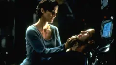 Carrie-Anne Moss and Keanu Reeves star in the original 1999 film