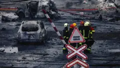 Rescue workers at the scene of a missile strike in Kyiv