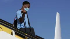 Sterling gets off a plane