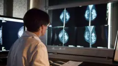woman looks at mammogram