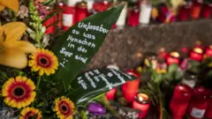 Vigil in Hanau - message reads 'inconceivable what people are able to do'