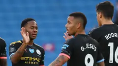 Raheem Sterling celebrates after putting City 1-0 up