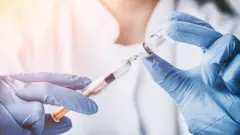 image of a woman doctor with syringe
