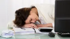 Businesswoman sleeping on desk