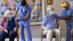 Beverly Coburn and husband John both receive their first dose of Moderna vaccine