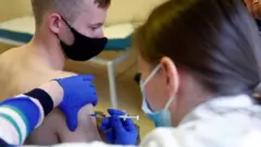 Un joven recibe la vacuna de Pfizer