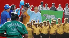 ပြည်သူ့ရှေ့ဆောင်ပါတီ(အပြာရောင်ဝတ်အမျိုးသမီး နှစ်ဦးက ကလေးချီထားတဲ့ အဝါရောင်ဝတ် အမျိုးသမီးတစ်ဦးကို မိုးပျံပူပြောင်း အပြာရောင်ပေး)၊ ကြံ့ခိုင်ရေးပါတီ ကြွေးကြော်စာ အစိမ်းရောင်ဝတ်ထားတဲ့အမျိုးသမီးက ကင်မရာကို ကျောပေးပြီးရပ်နေ၊ ပြည့်သူ့ပါတီဝင် အမျိုးသား ၉ ဦးနဲ့ အမျိုးသမီး ၁ ဦးက ကင်မရာကို ကြည့်ပြီး လက်ဆန့်တန်း လက်မထောင်နေ၊ ကျားဖြူပါတီ ကိုယ်စားပြု အဖြူရောင်ကျားရုပ်နဲ့ အစိမ်းရောင် ပိတ်စကို အမျိုးသား ၅ ၄ ဦးနဲ့ အမျိုးသမီး ၁ ဦးတို့ ကိုင်ပြီး မတ်တပ်ရပ်နေကြတဲ့ပုံတွေကို အနီရောင်နောက်ခံနဲ့ ပေါင်းစပ်ထားတဲ့ ဓာတ်ပုံဖြစ်ပါတယ်။