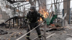 Trabalhadores dos serviços de emergência na Ucrânia atendem a um incêndio em um hangar destruído por um ataque de drone.