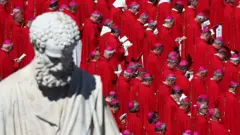 Saint Peter's statue and cardinals during the funeral ceremony of Pope Francis