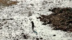 Um sentinelese armado de arco e flecha