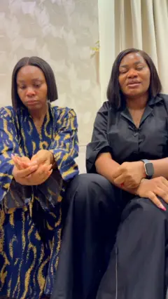 Two sisters sit side by side to speak with BBC News Pidgin