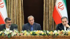 Behrouz Kamalvandi, left, Ali Rabiei, centre, and Abbas Araqchi, right, address the press