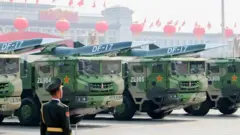 Image shows DF-17 medium-range ballistic missiles equipped with a DF-ZF hypersonic glide vehicle, involved in a military parade to mark the 70th anniversary of the Chinese People's Republic