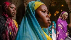 Pilgrims leave the mausoleum in the Great Mosque of Touba during the Grand Magal of Mourides in Touba on September 26, 2021, the largest annual muslim pilgrimage in Senegal, with hundreds of thousands making the pilgrimage each year.