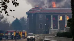 Firefighters try to extinguish a fire in the Jagger Library, at the University of Cape Town
