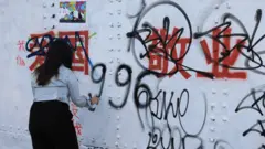 倫敦紅磚巷一位女子在中國政治標語上反制塗鴉（6/8/2023）