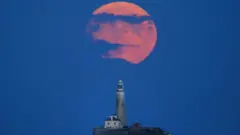The Full Buck supermoon rises over St Mary's Lighthouse in Whitley Bay on 2 July