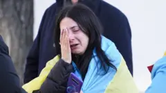 A Ukrainian woman cries following the Russian invasion