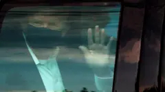 US President Donald Trump rides in front of the Walter Reed National Military Medical Center