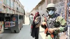 Taliban and Pakistani soldiers guard Afghanistan's border