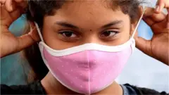 A girl wears a mask in Bangalore, India. Photo: 16 September 2020