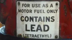 Vintage petrol pump in Nashville, Tennessee, with a sign saying that the petrol contains lead
