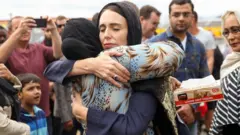 New Zealand Prime Minister Jacinda Ardern hugs a mosque-goer at the Kilbirnie Mosque in Wellington, following the mass shooting attacks on two mosques in Christchurch in 15 March 2019.